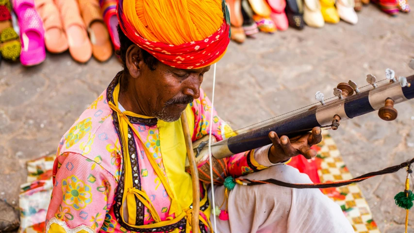 a man in a bright colored outfit playing a musical instrument