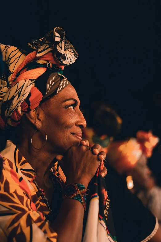 a woman is wearing a head scarf with beads