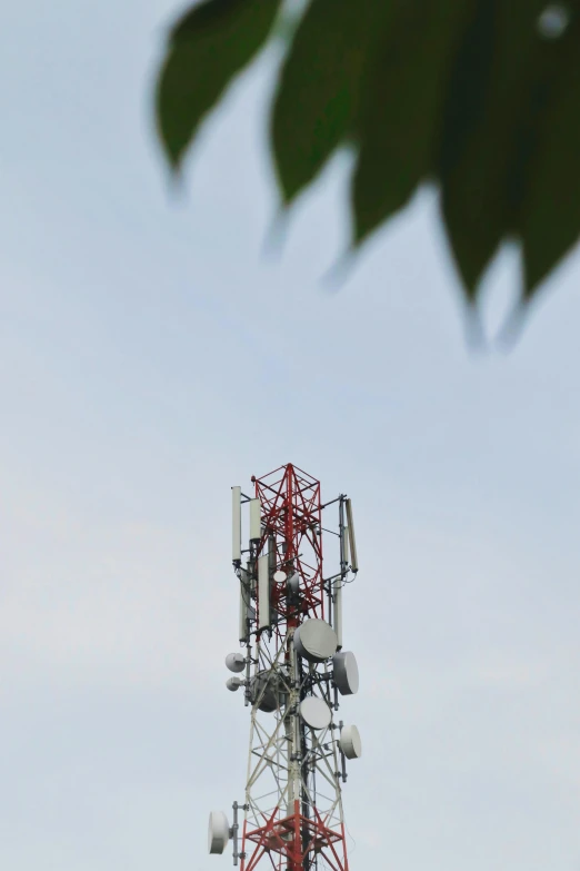 a white tower that has some cellular towers on it