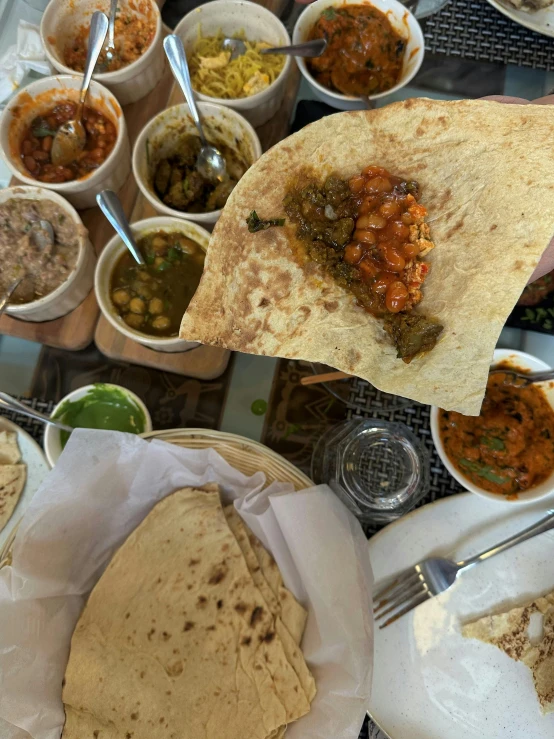 mexican food is served in bowls and wraps