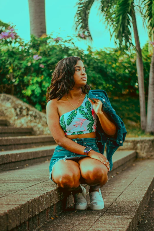 a beautiful young woman sitting on some stairs