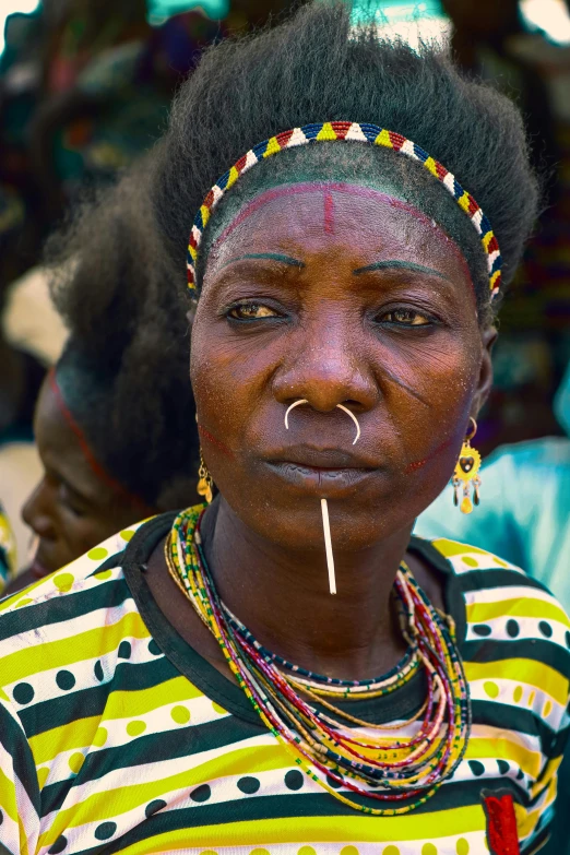 the woman is wearing a big necklace and earrings