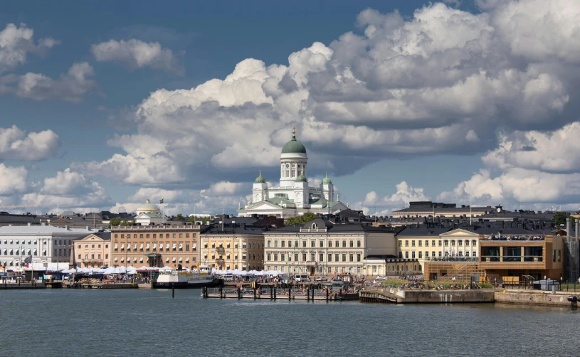 there is a large white building and towers on top of this city