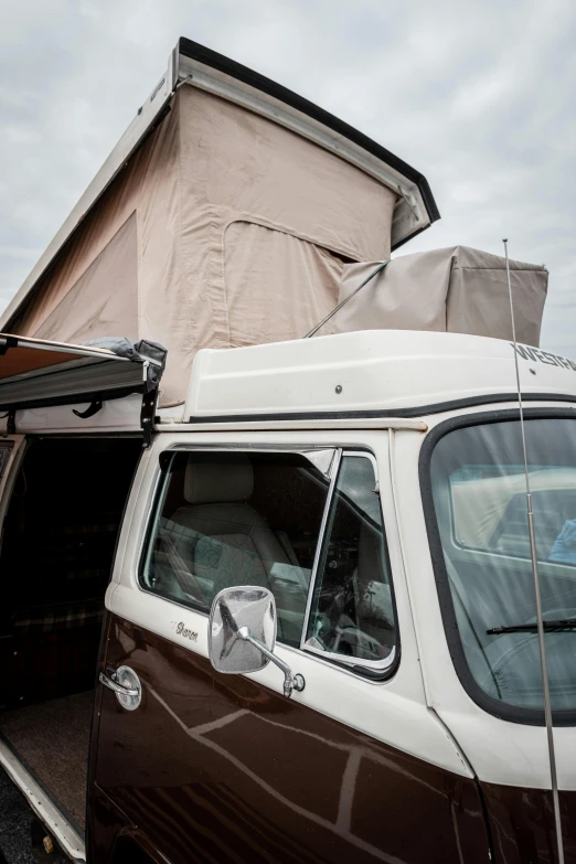 a camper van is parked outside with a canvas roof