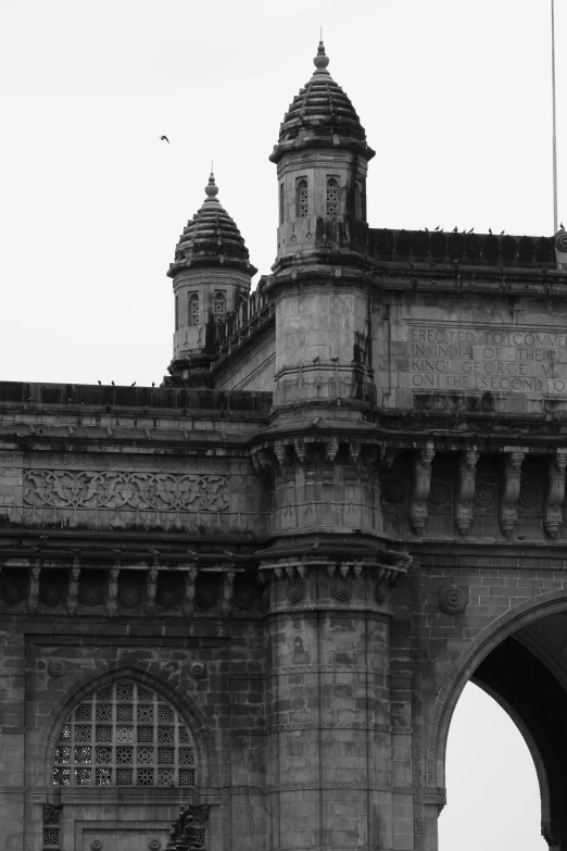 black and white image of an old clock tower in india