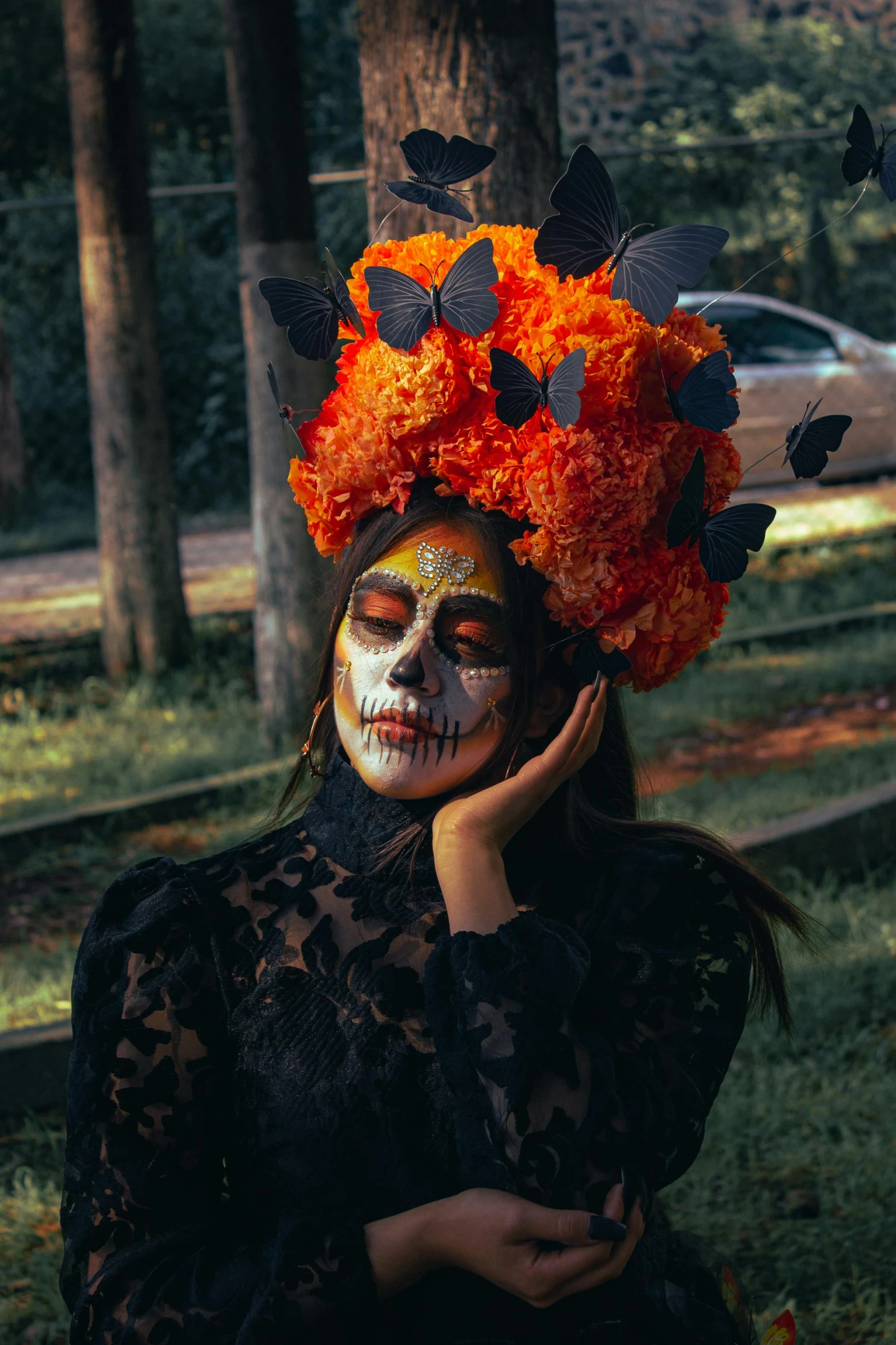 a woman is seen with her makeup on and a halloween skull headpiece