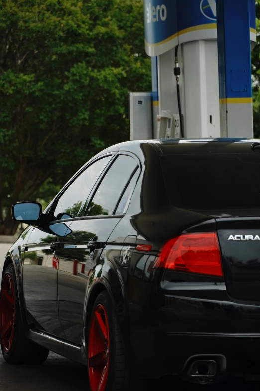 an automobile is seen in front of gas pumps