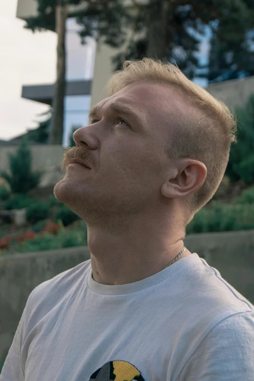 a man in a white shirt with a yellow and black bird on it