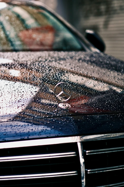 closeup of car windshield covered in water droplets