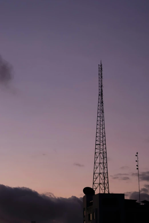 a tall tower with some clouds in the background