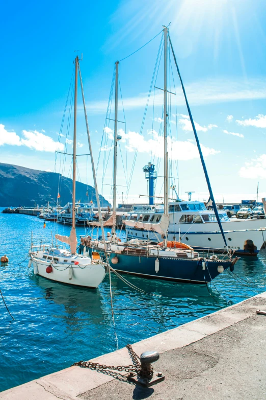 a group of boats parked in the ocean at a marina