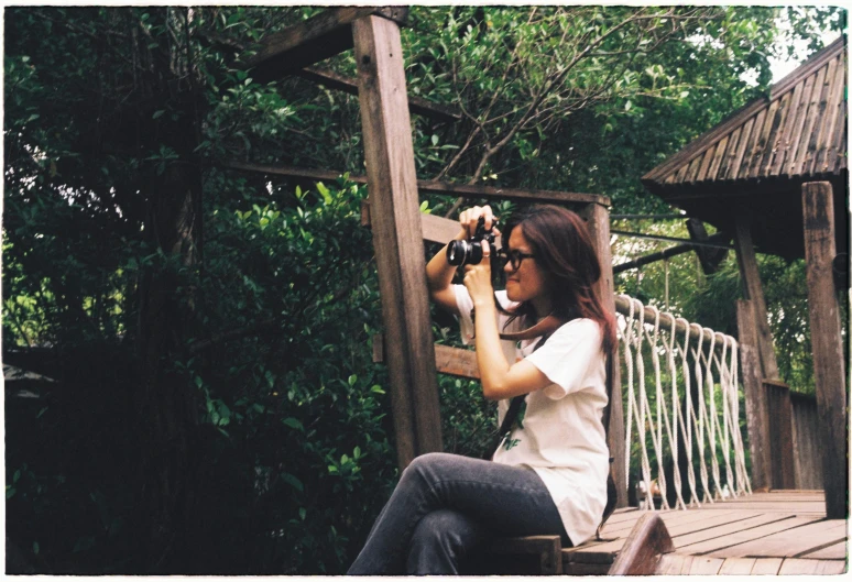 a woman in jeans and white shirt taking a po