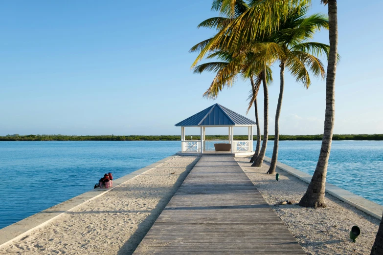 a pier and gazebo on a tropical beach