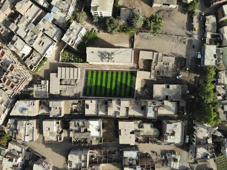 an aerial view shows a small patch of grass near houses