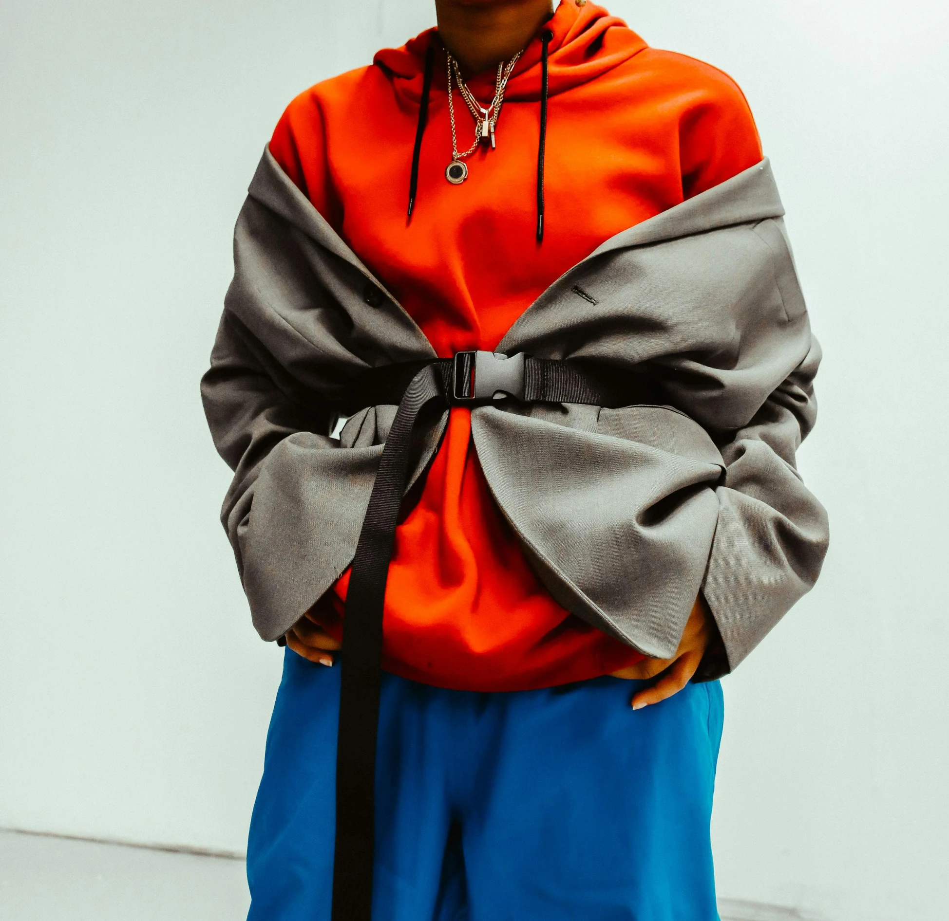 a man with a black hat and orange shirt