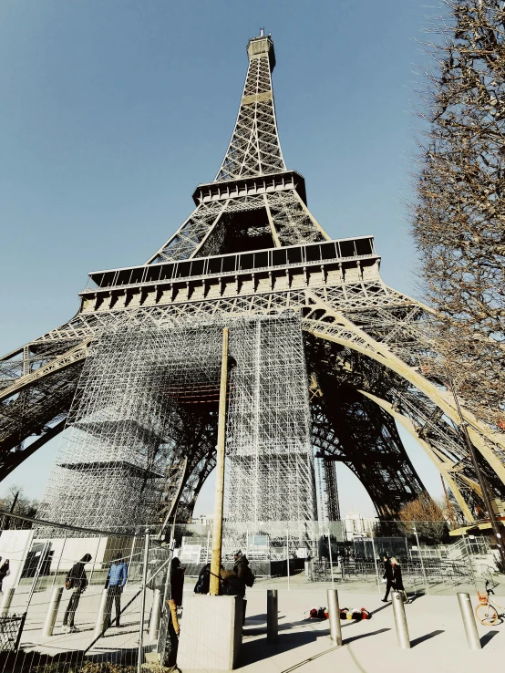 the eiffel tower is shown through the fence