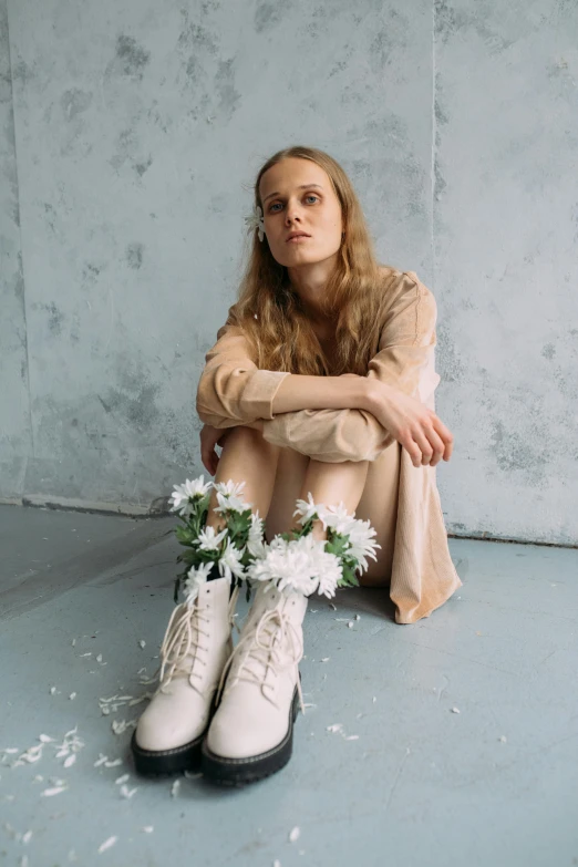 a woman in a white skirt and white boots