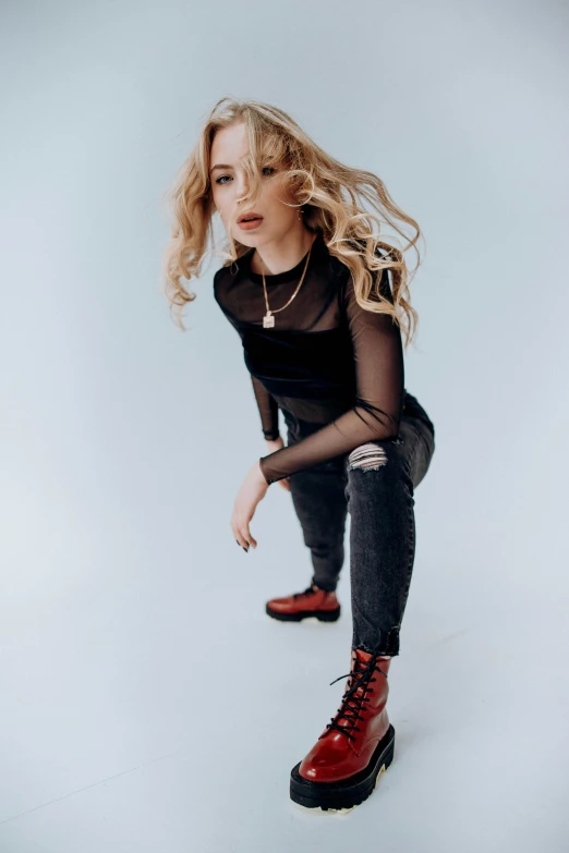 a woman kneeling on top of a skateboard