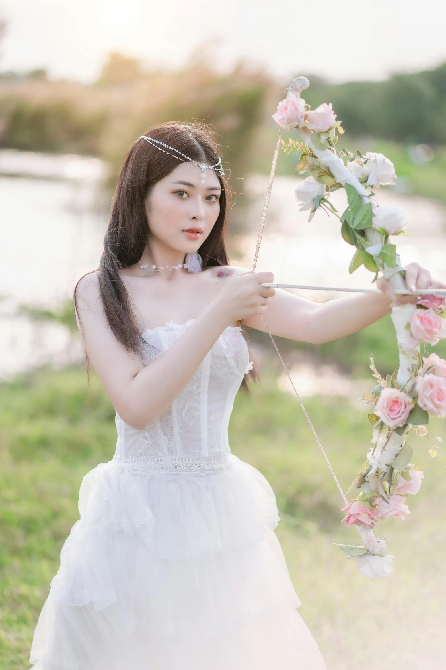 a woman dressed up with flowers holds a stick