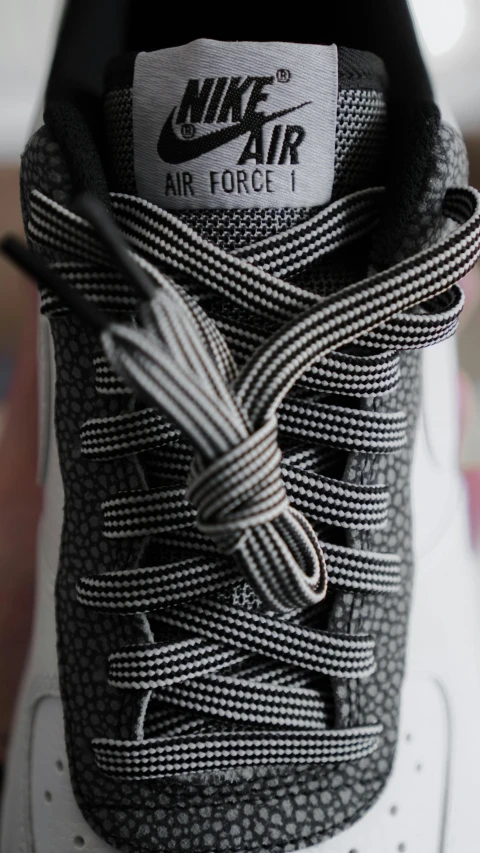 a nike air force 1 sneaker's laced up with string on the side