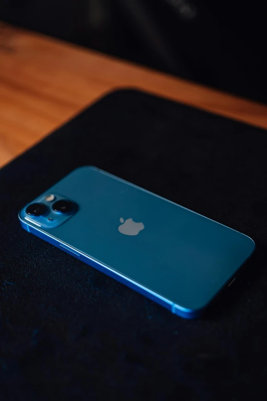 a bright blue iphone with a small apple logo on the back