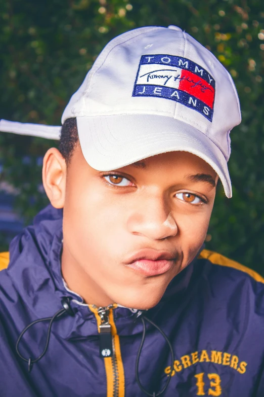 a boy wearing a hat with some sort of blue and red on it