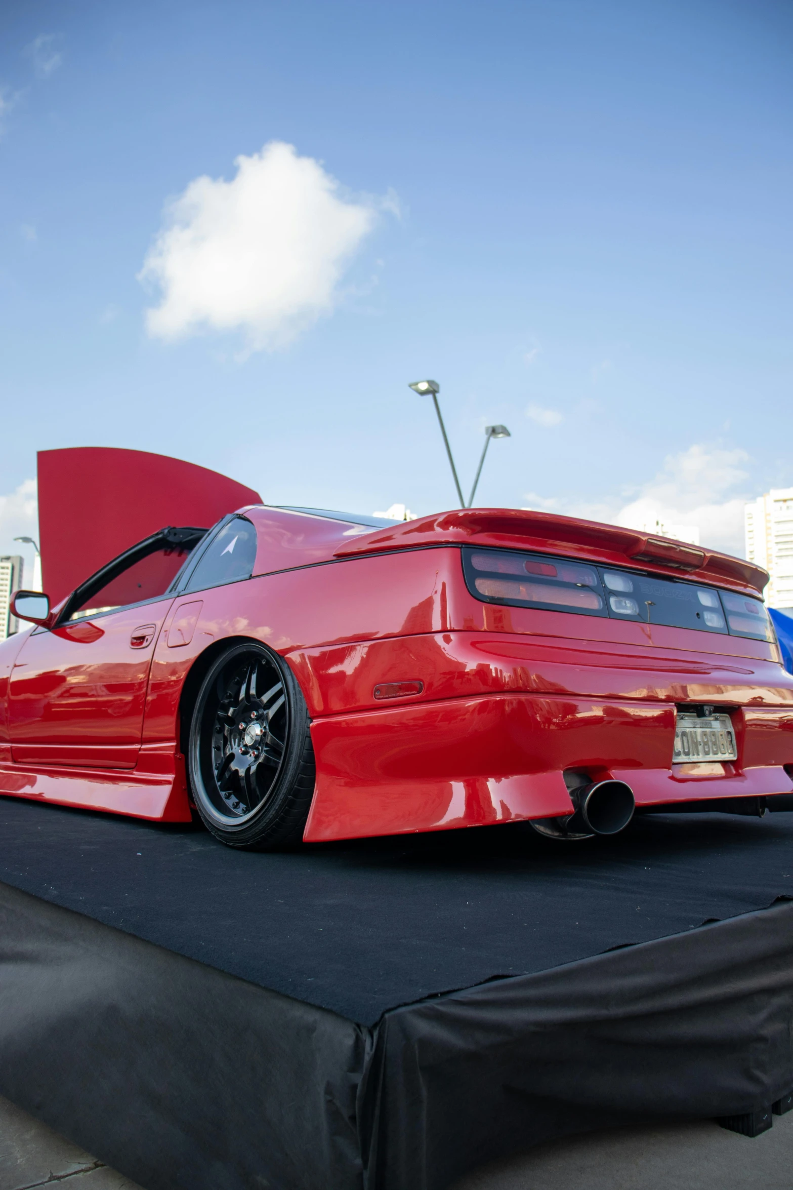 a bright red car is on display for everyone to see