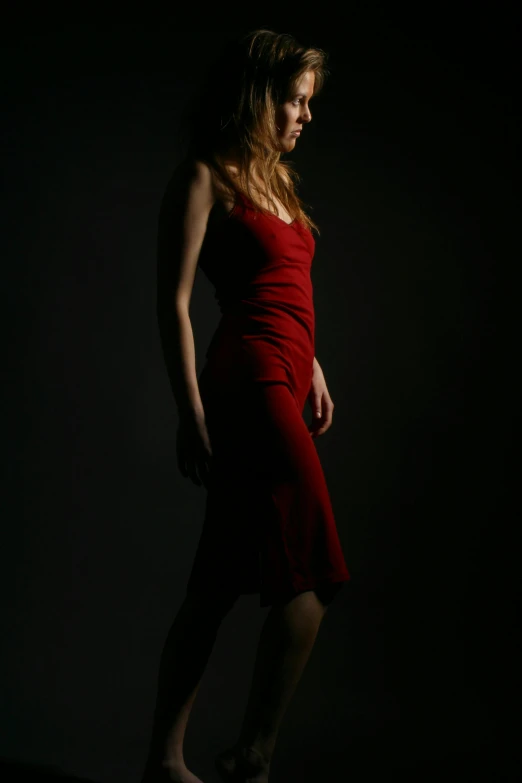 a woman in a red dress standing up