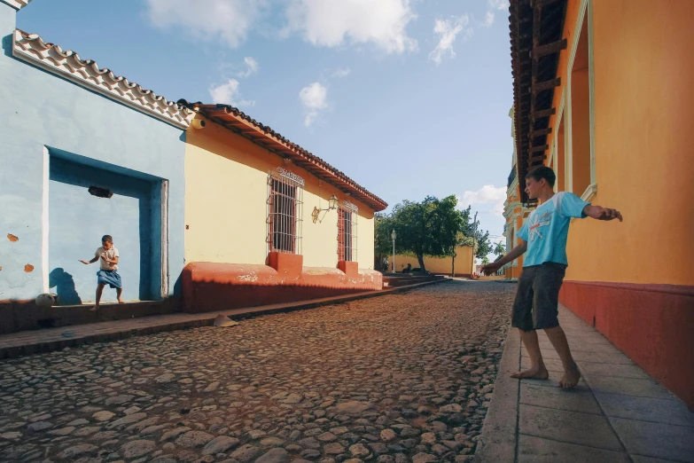 a person standing on a street near a building