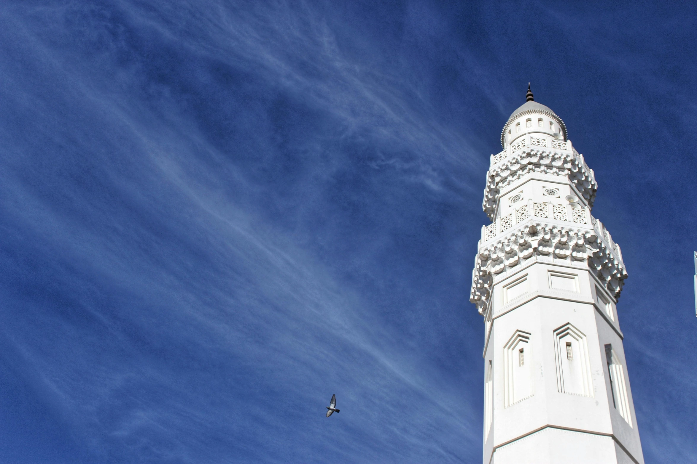 a tall white tower with a clock on the top