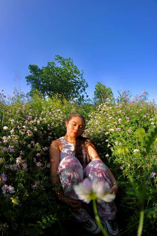 a person kneeling down and posing in a field