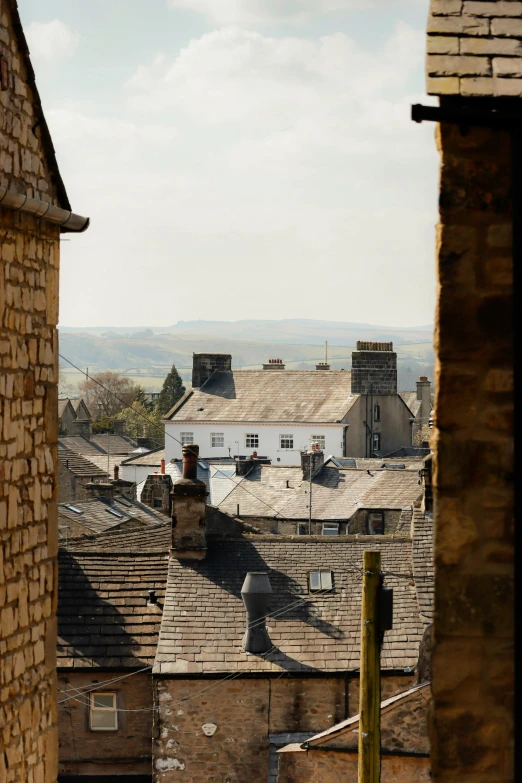 a view from a window showing buildings and roofs