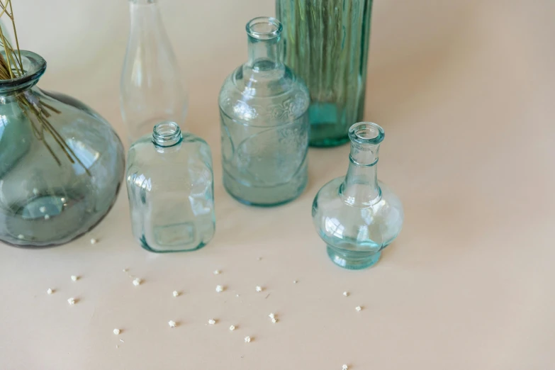 various different glass containers and vases all lined up together