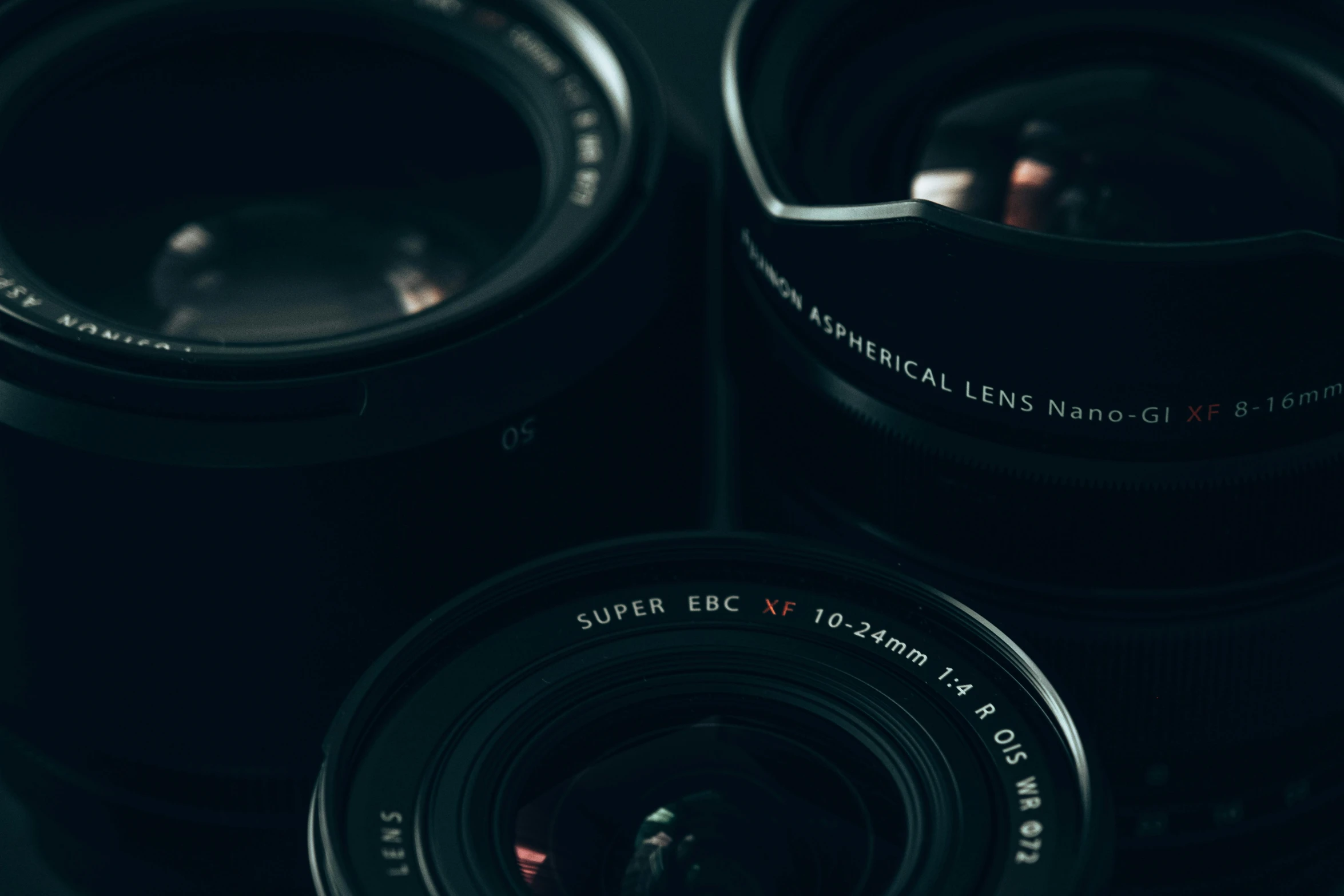 two old black cameras sitting in a pile