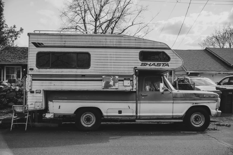 an old truck sitting parked next to a house