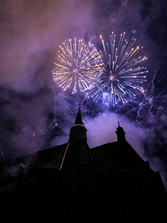 a view from the roof of a building with fireworks going off