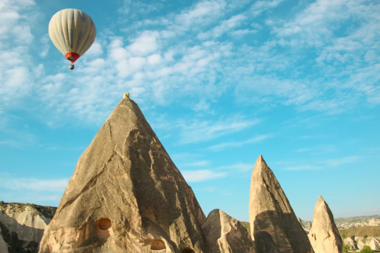 a  air balloon flying near rocks in the desert