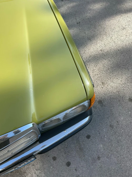 a car headlight is shown on an orange vintage car