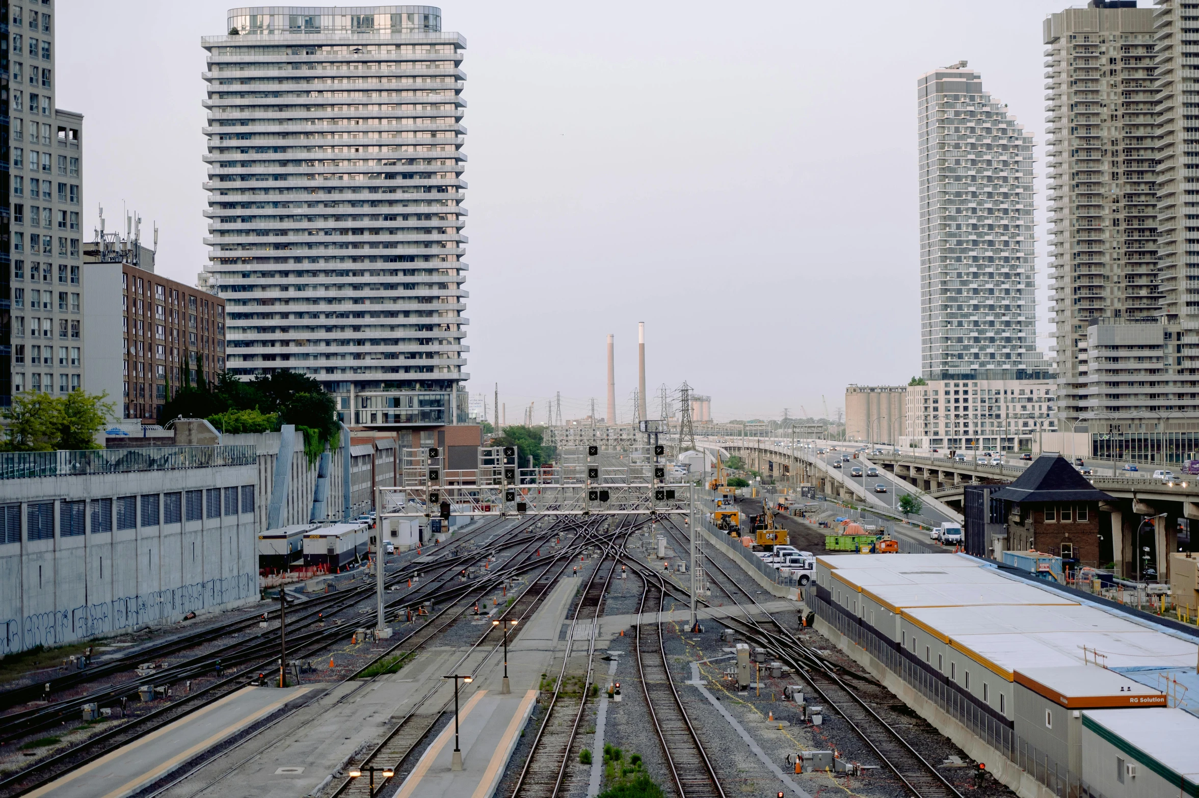 a train station with several sets of train tracks running through the city