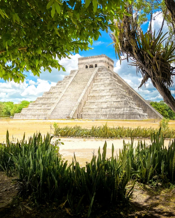 a very large pyramid with people standing around it