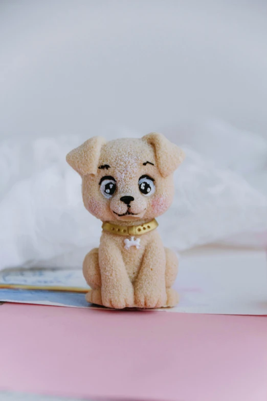 a small stuffed dog on top of a pink counter