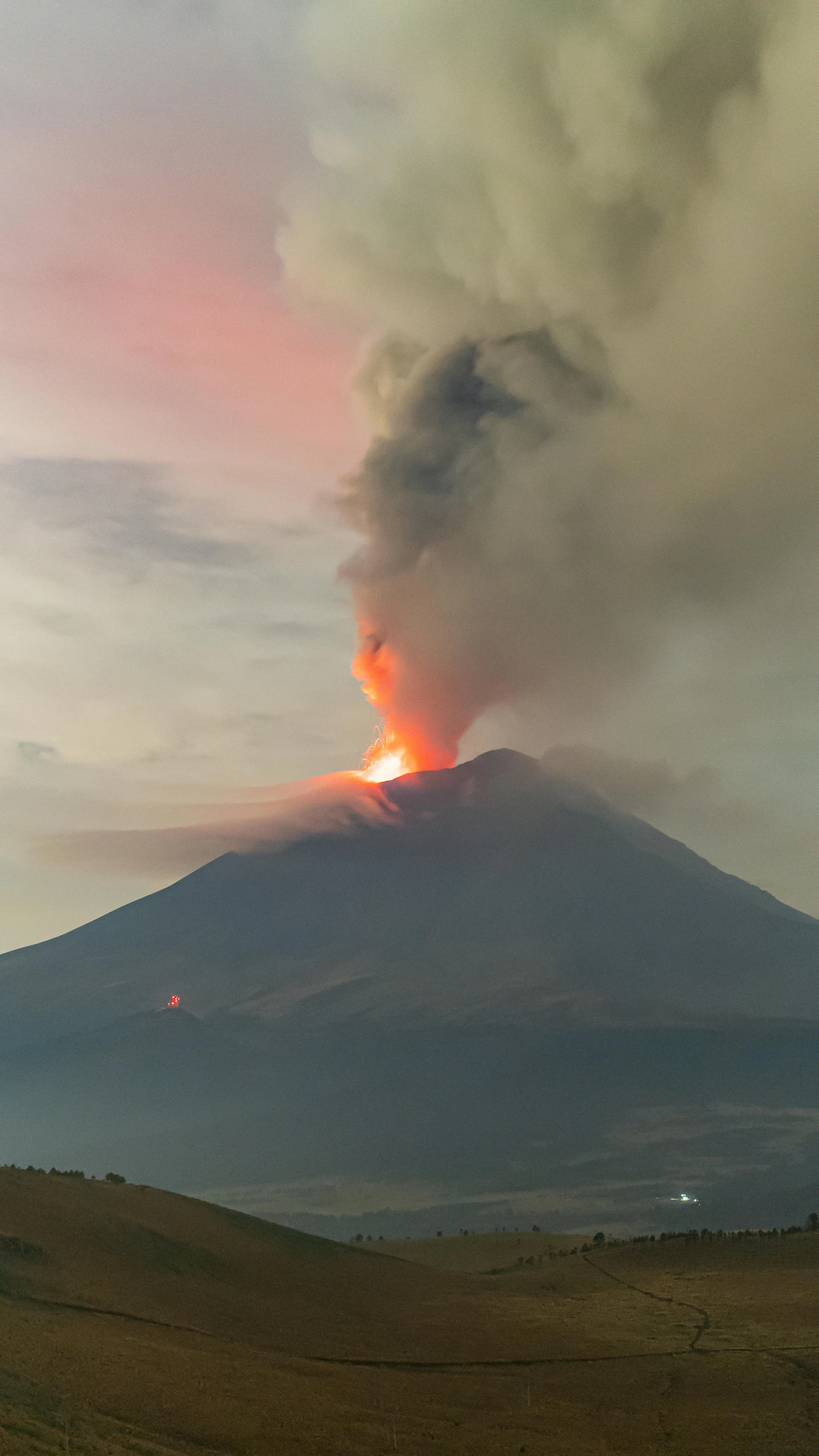 a volcano is on fire on the hillside