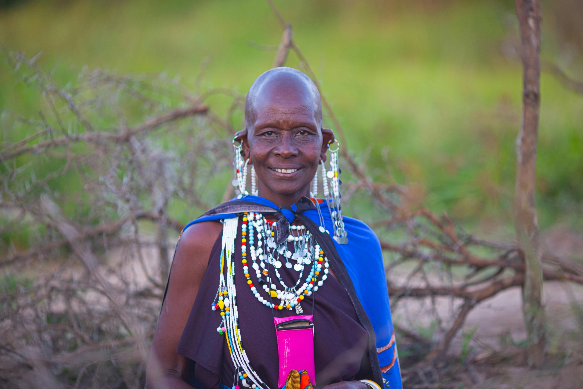 an old african woman is smiling for the camera