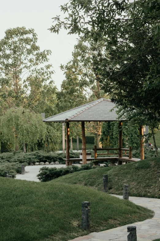 a garden with an arbor in the foreground