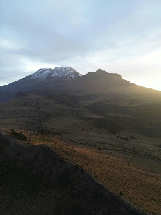 there is a mountain side with trees on it