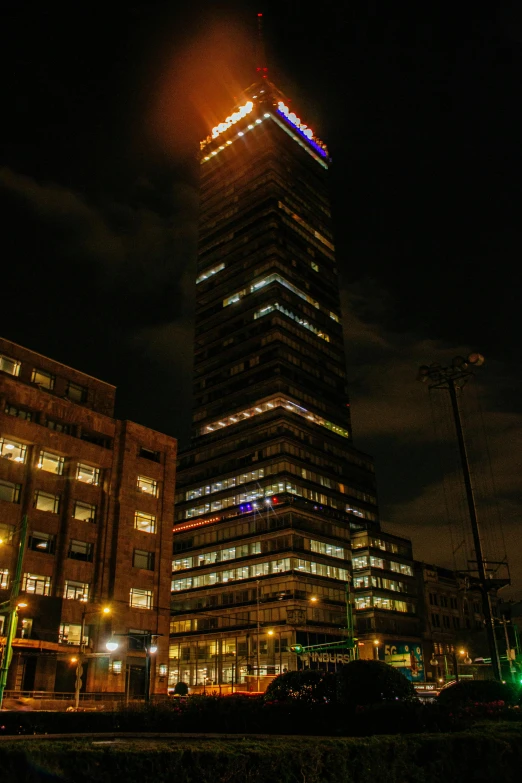 a very tall building with windows lit up