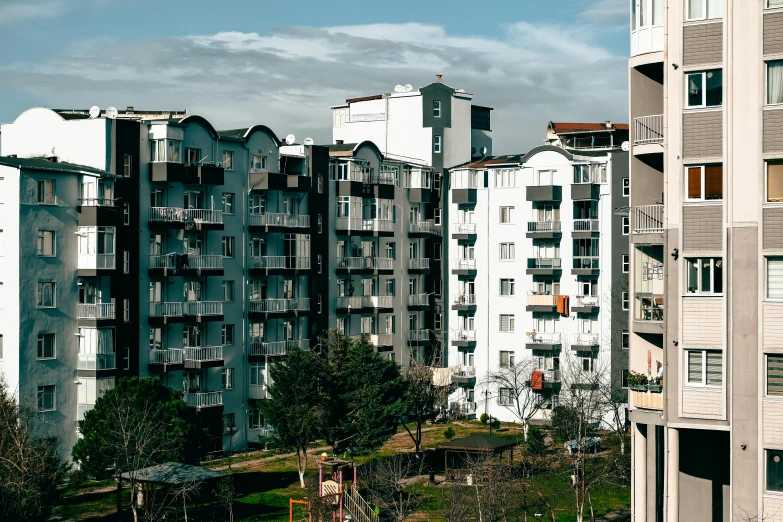 several large apartment buildings in front of a parking lot