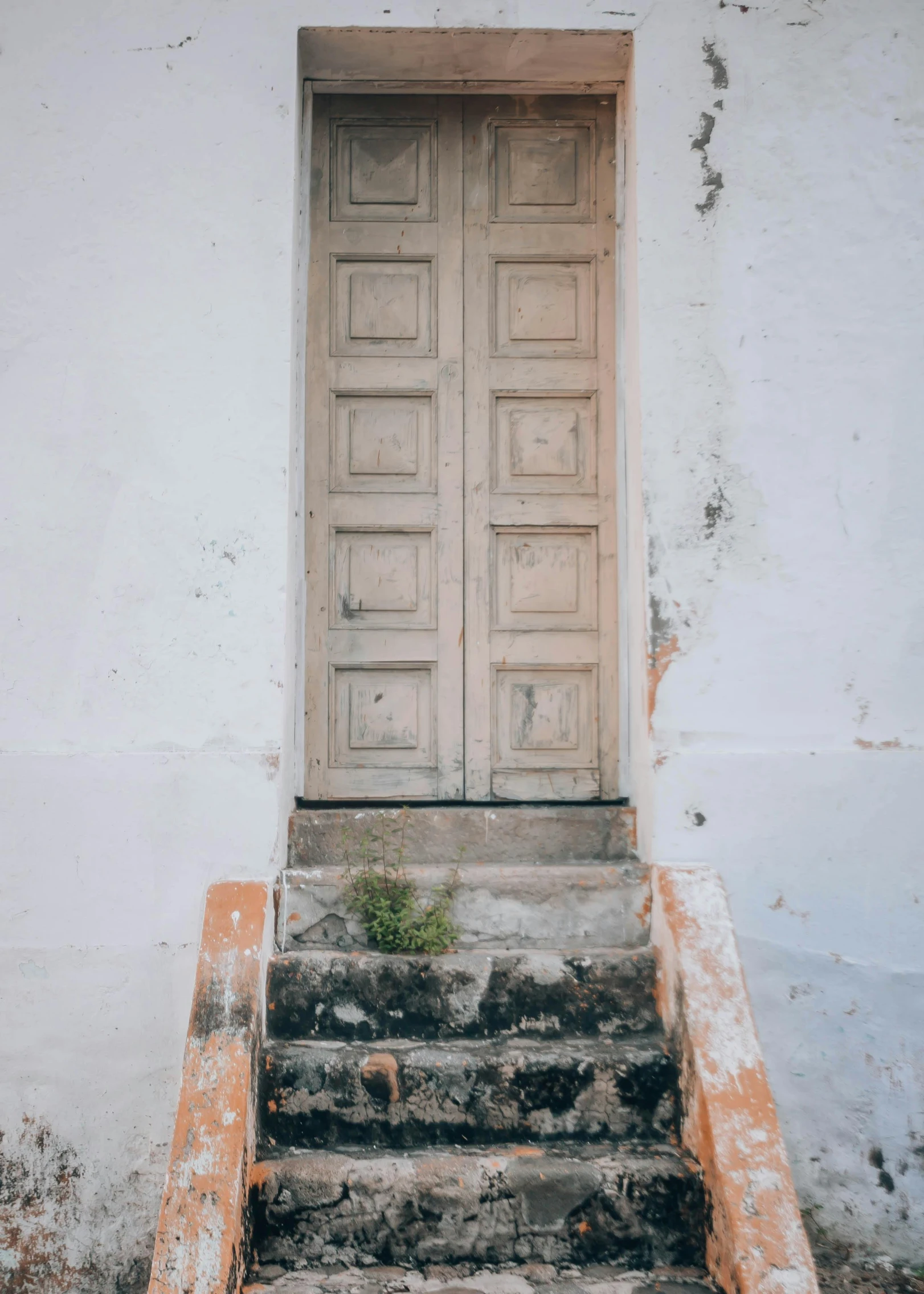 there is stairs going up to a door