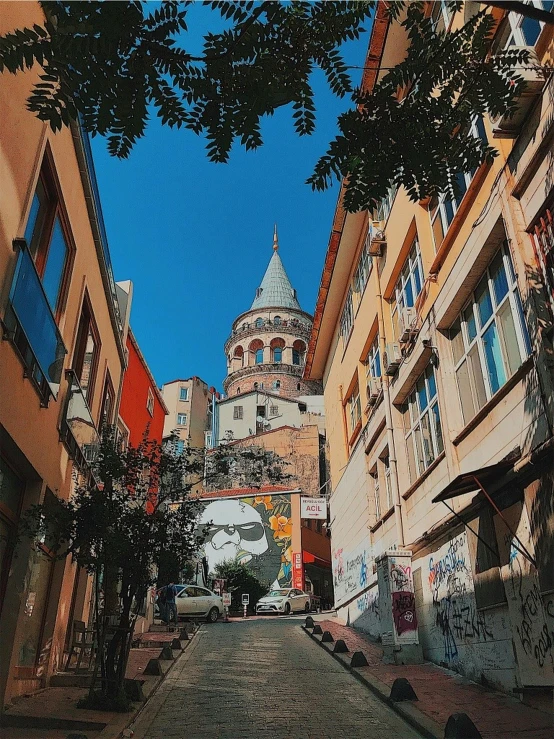 a view of a street and clock tower from another end