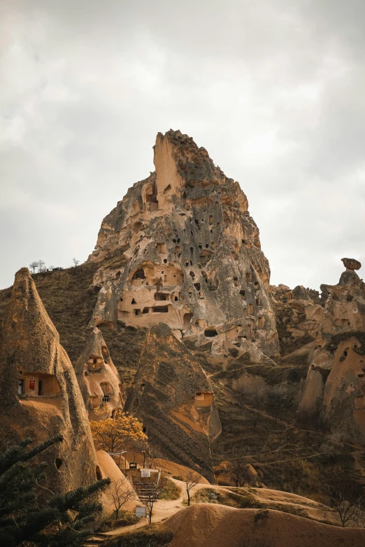 a rocky mountain with many carved rocks on it